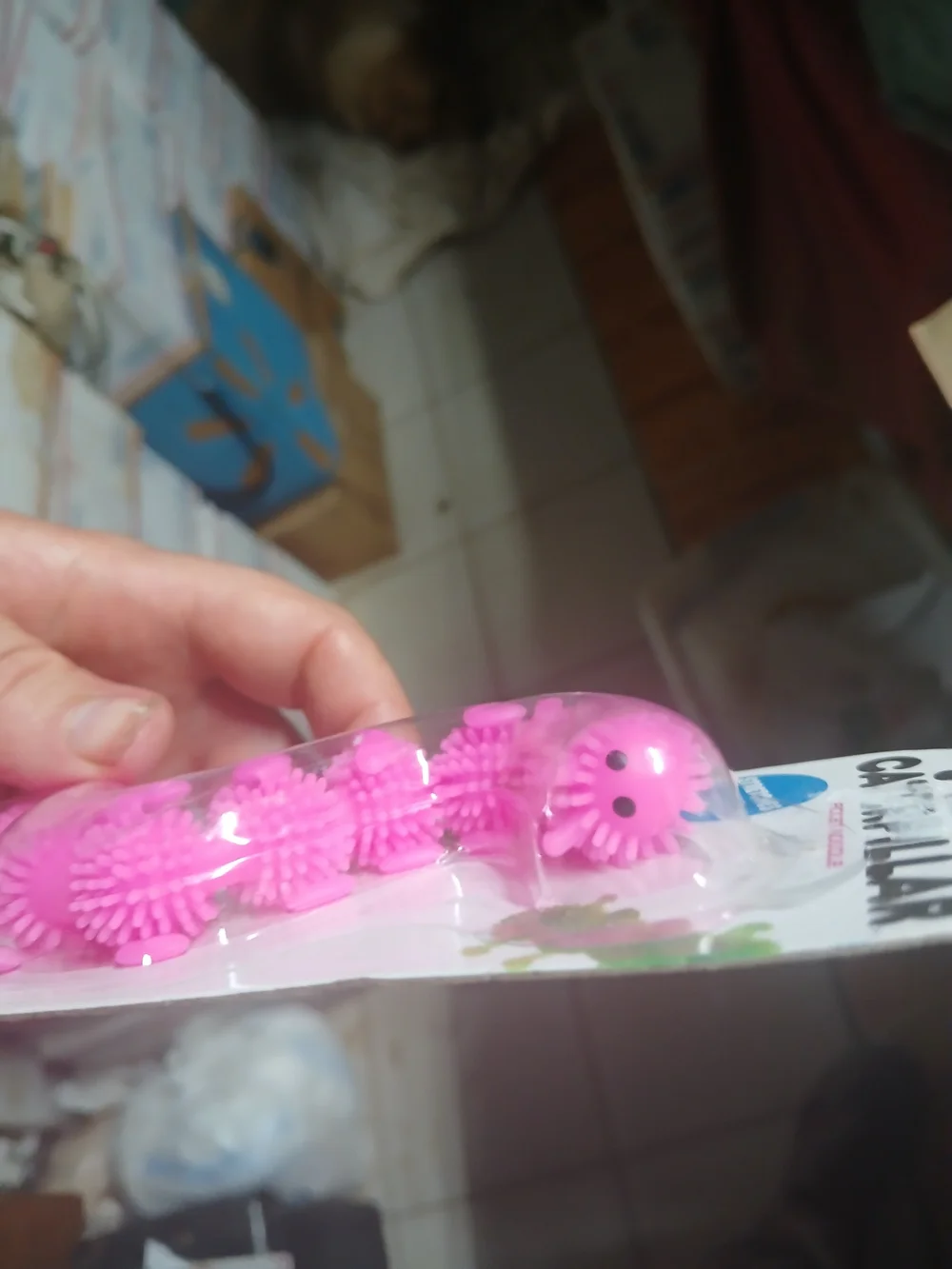 a pink stretchy caterpillar fidget toy with bumpy textures, made by Big Time Toy